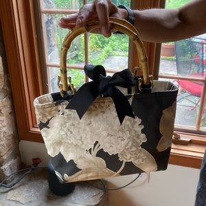 Darling fabric purse with bow closure.